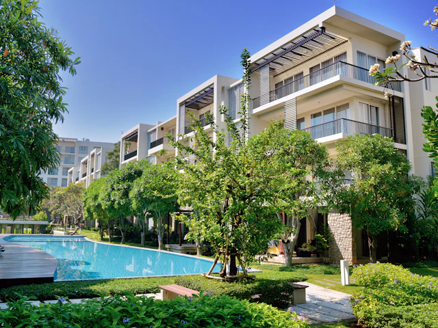 An apartment community with a pool and gardens